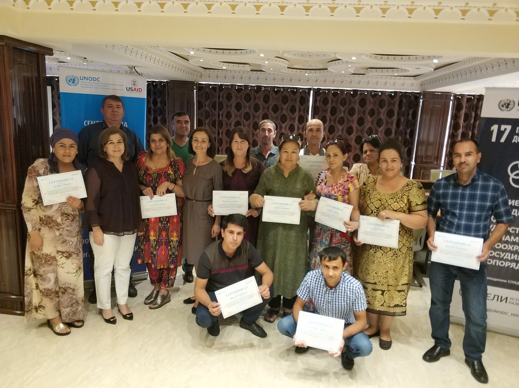 Group picture of men and women holding certificates in their hands