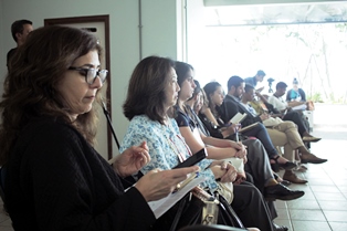 Women sitting in a row at a conference