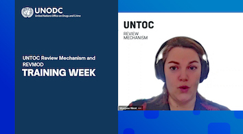 A visual with the image of a woman speaking and the logo of UNODC. The following text appears on the visual: "UNTOC Review Mechanism and REVMOD - Training Week". 