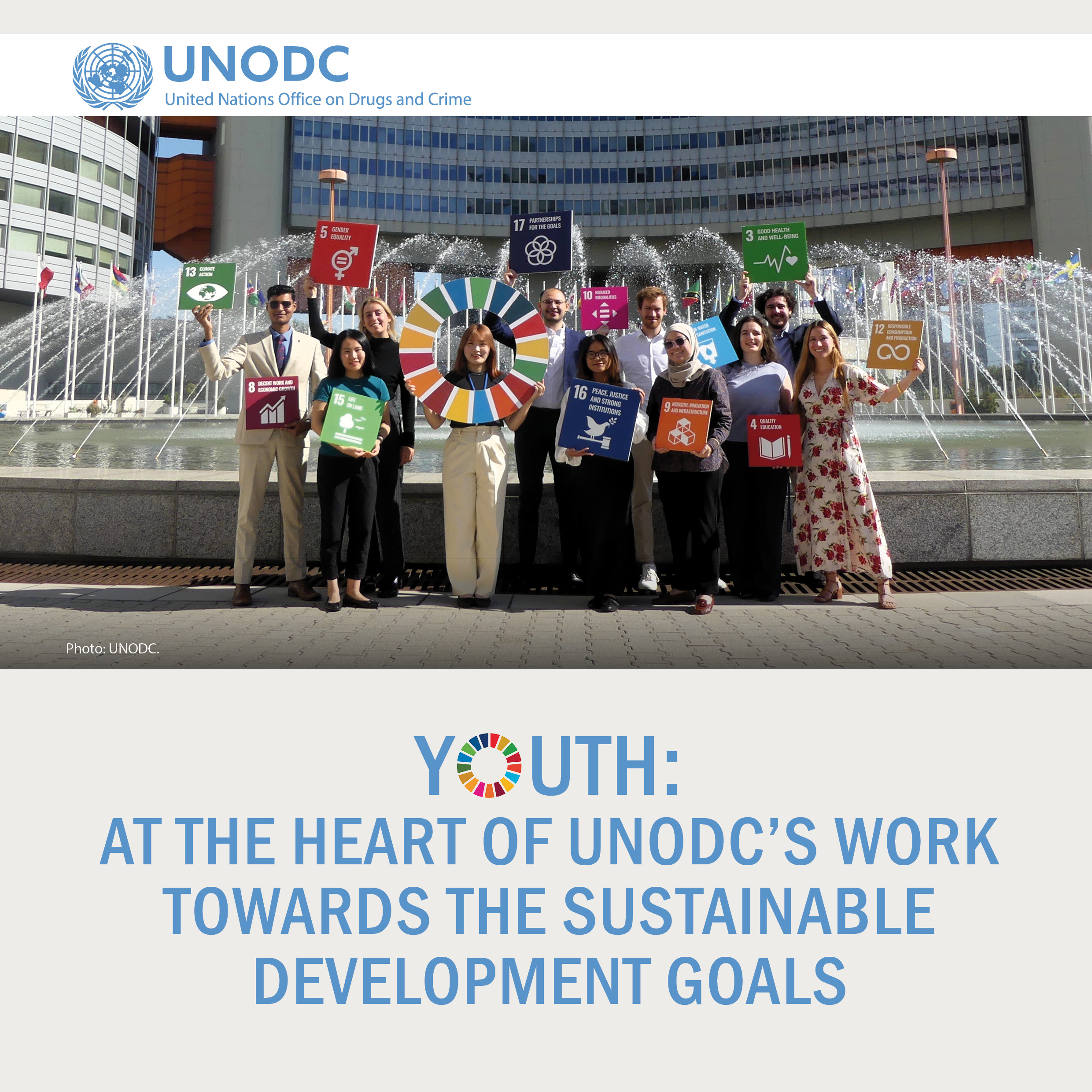 Cover page of the brochure YOUTH: At the heart of UNODC's work towards the Sustainable Development Goals. There is a photo featuring a group of young people holding SDG signs in front of a fountain at UNODC's headquarters in Vienna, Austria. 