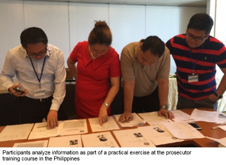 Participants analyze information as part of a practical exercise at the prosecutor training course in the Philippines