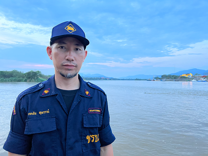 Village security volunteer Eakkachai Suphan in his uniform in front of Mekong river.