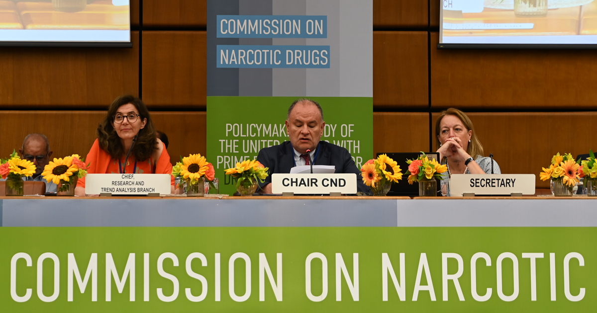 Three panelists sit behind a desk at a special event of the Commission on Narcotic Drugs' launch of the World Drug Report 2023. 