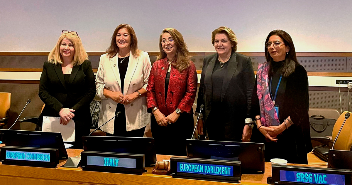 Five women, panelists at the “Children’s Rights in the Digital Environment” discussion, stand behind a desk, including UNODC Executive Director Ghada Waly.