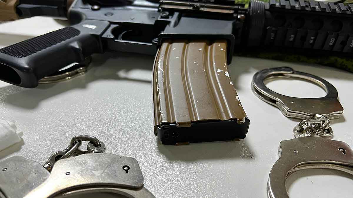 fake gun, handcuffs, and mobile phone