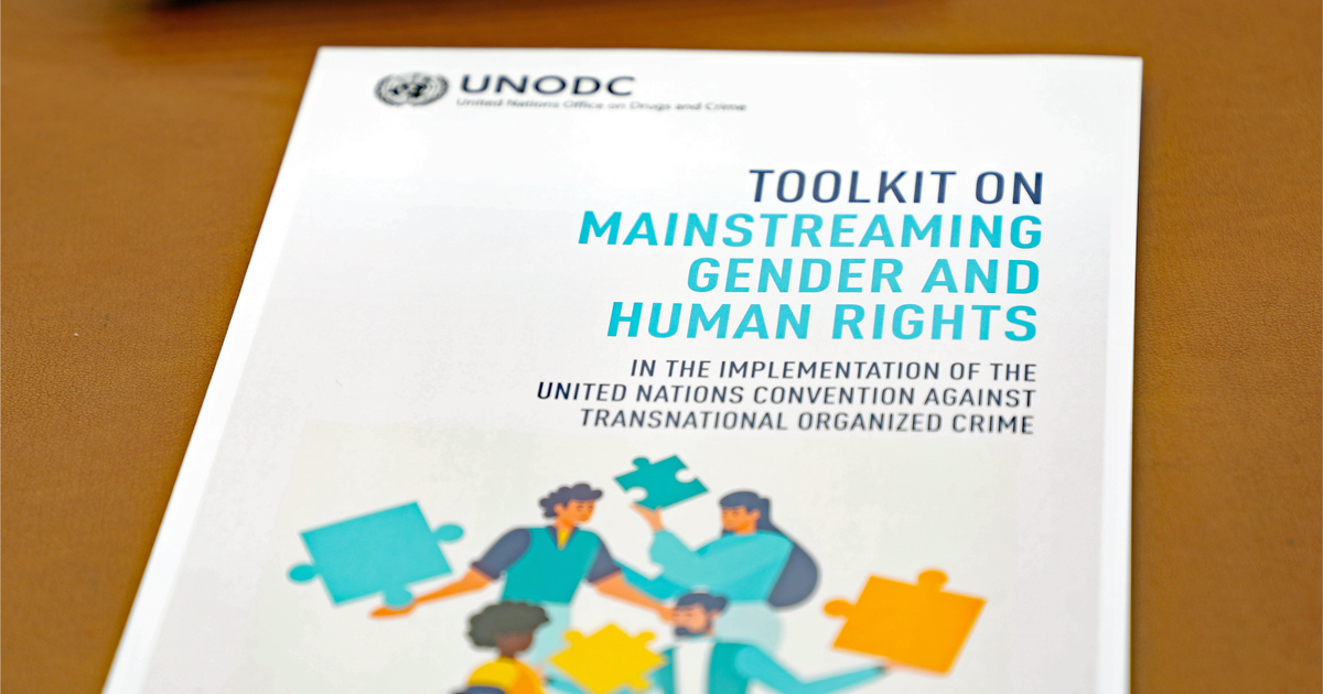 A photo with the cover page of UNODC Toolkit on Mainstreaming Gender and Human Rights in the Implementation of the United Nations Convention against Transnational Organized Crime