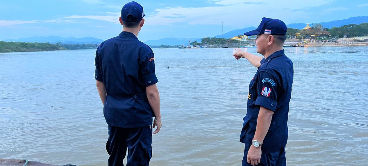 Village security volunteer, Eakkachai Suphan, (left) and a colleague look over the Mekong River in the Golden Triangle.