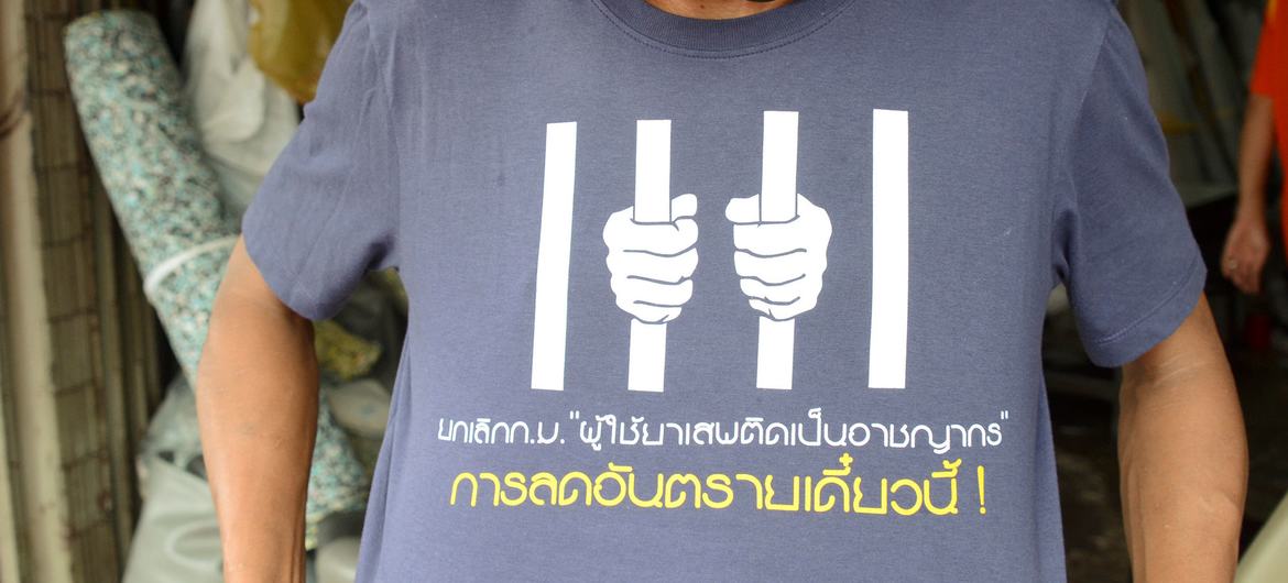 An activist in Thailand wears a t-shirt which calls for people who use drug harm reduction initiatives not to be criminalized.